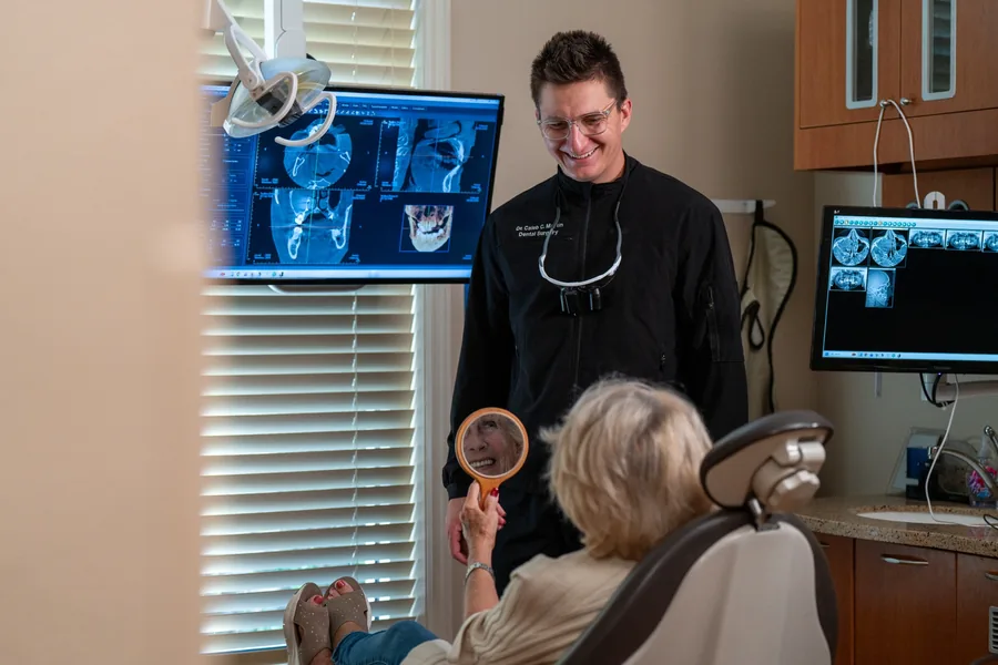 A patient viewing her smile with Caleb Martin