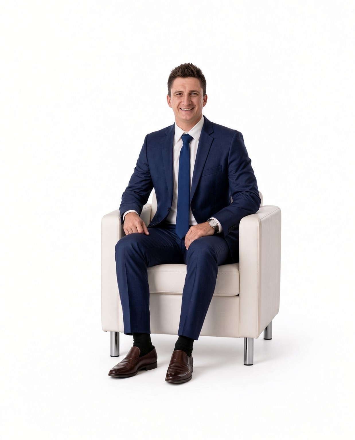 Caleb Martin, DMD seated in a cream chair wearing a navy suit
